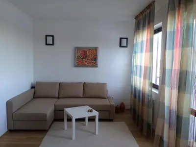 a living room with a couch and a table at Stenata Boutique Apartments in Pamporovo