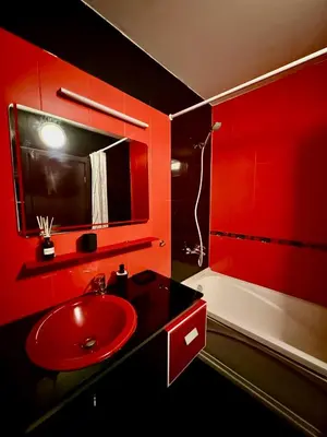 a red bathroom with a red sink and a tub at Stenata Boutique Apartments in Pamporovo