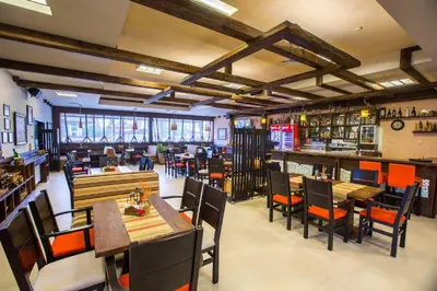 a restaurant with tables and chairs and a bar at Complex Jitari in Zhitnitsa