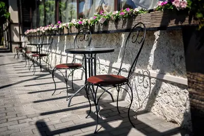 a row of tables and chairs on a brick sidewalk at Complex Jitari in Zhitnitsa