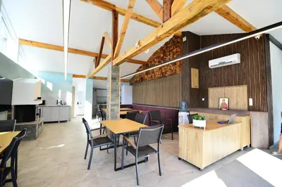 a dining room with wooden tables and chairs at Hit Hot House in Sandanski
