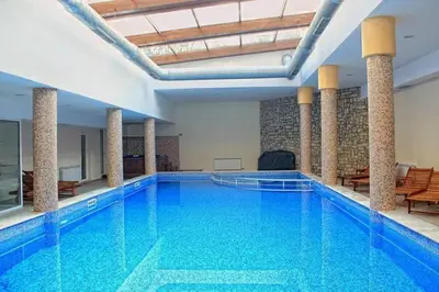 a large swimming pool in a large building at 650m Ski in&out - Studio - FREE SPA and Parking in Bansko