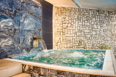 a jacuzzi tub with a water fountain at 650m Ski in&out - Studio - FREE SPA and Parking in Bansko