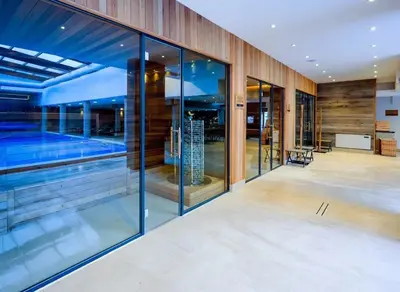 an external view of a house with a swimming pool at 650m Ski in&out - Studio - FREE SPA and Parking in Bansko