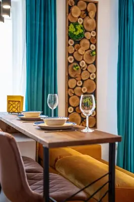 a wooden table with two wine glasses on it at Mountain Studio - Ski in and out - FREE Spa in Bansko