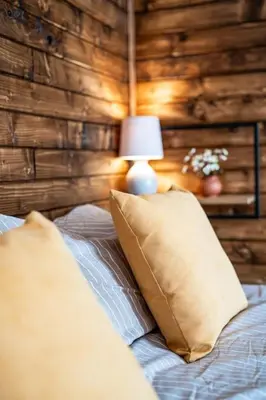 a bedroom with a bed with two pillows and a lamp at Mountain Studio - Ski in and out - FREE Spa in Bansko