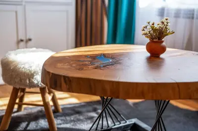 a wooden table with a vase of flowers on it at Mountain Studio - Ski in and out - FREE Spa in Bansko