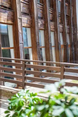 a fence in front of a building with windows at Mountain Studio - Ski in and out - FREE Spa in Bansko