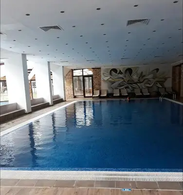 a large swimming pool in a hotel room at Lorena Holiday Spa Свети Спас in Velingrad