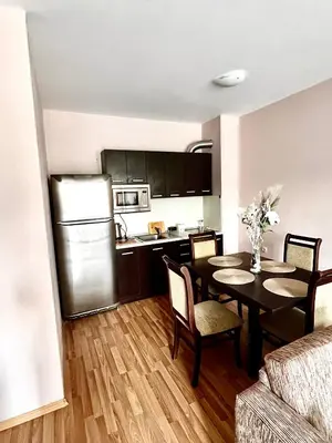 a kitchen and dining room with a table in a room at Lorena Holiday Spa Свети Спас in Velingrad