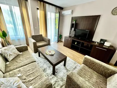 a living room with two couches and a tv at Lorena Holiday Spa Свети Спас in Velingrad