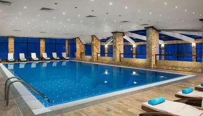 a large swimming pool in a hotel room at Lorena Holiday Spa Свети Спас in Velingrad