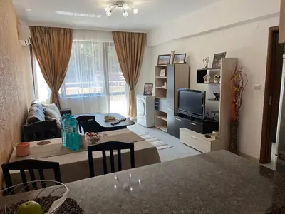a living room with a couch and a table and a television at Ideal Center by the Park - Walk to Kapana in Plovdiv
