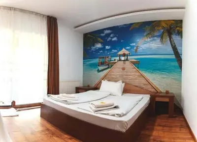 a bedroom with a large painting of a beach at Комплекс Тракийски стан in Asenovgrad