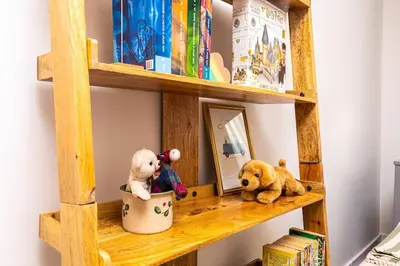 a wooden shelf with stuffed animals and a mirror at Central Family Apt Fuzzy Muzzy 2 bedrooms MU University in Plovdiv