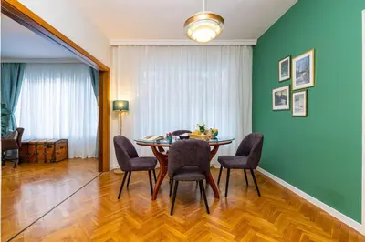 a dining room with a table and chairs at Central Family Apt Fuzzy Muzzy 2 bedrooms MU University in Plovdiv