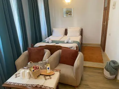 a small room with two beds and a couch at Dvata Smurcha Central Apartments - Free Parking in Bansko