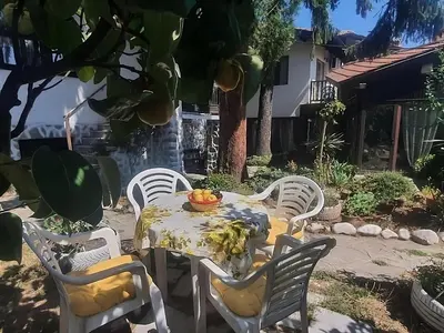a table and chairs with a bowl of fruit on it at Dvata Smurcha Central Apartments - Free Parking in Bansko