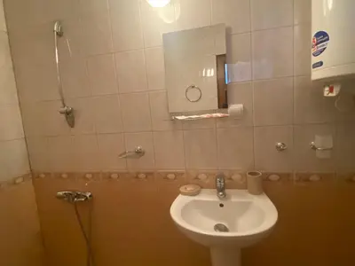 a bathroom with a sink and a mirror at Dvata Smurcha Central Apartments - Free Parking in Bansko