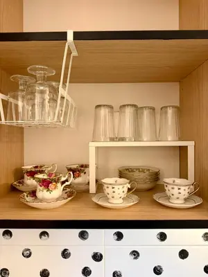 a shelf with cups and plates and bowls on it at Palermo Family designer Apt near UNSS w Fast WiFi in Sofia