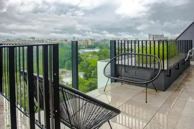 a balcony with a chair and a view of a city at Palermo Family designer Apt near UNSS w Fast WiFi in Sofia