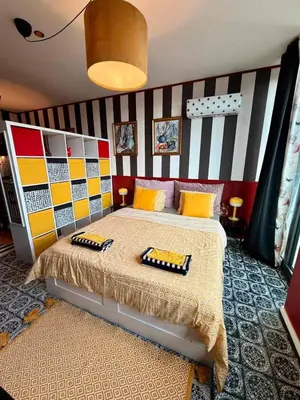 a bedroom with a bed with a striped wall at Palermo Family designer Apt near UNSS w Fast WiFi in Sofia