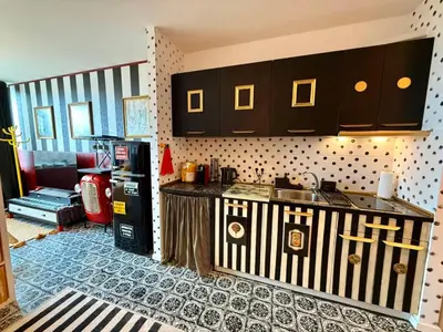 a kitchen with a refrigerator and a counter top at Palermo Family designer Apt near UNSS w Fast WiFi in Sofia