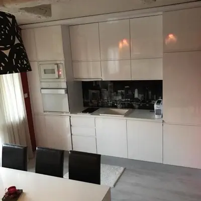 a kitchen with white cabinets and a table and chairs at Sequoia Loft apartment in Borovets