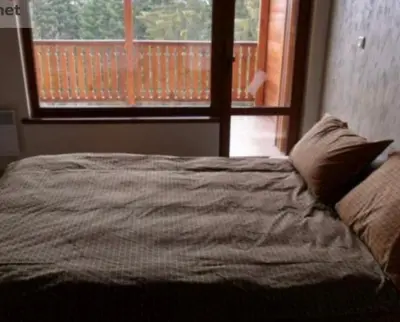 a bedroom with a bed and a window with a view at Sequoia Loft apartment in Borovets