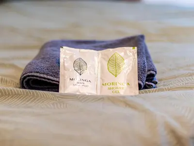a towel and a bag on a bed at Stay & Explore Sofia - Central Studio in Sofia