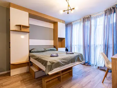 a bedroom with a bed and a large window at Stay & Explore Sofia - Central Studio in Sofia