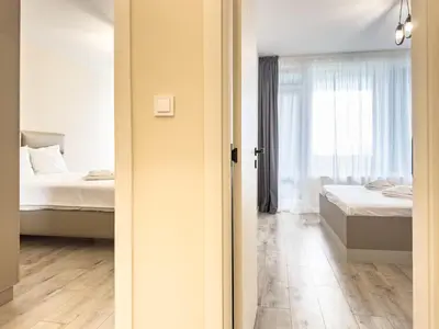 a bedroom with two beds and a window at 2BR Business Suite with FREE GYM, by Holiwork Stays in Plovdiv