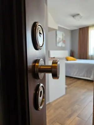 a doorhandle to a bedroom with a bed in the background at Studio Secrets in Plovdiv