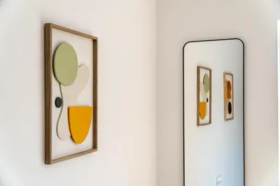 a mirror on a wall with three pictures at Vintage Parkside whit Free Parking near Center in Plovdiv