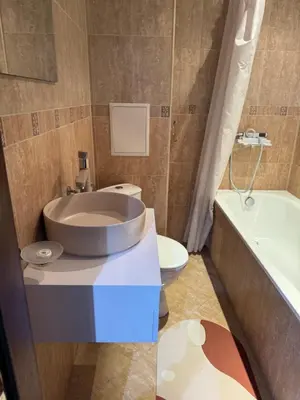 a bathroom with a sink and a toilet and a tub at 1-Bedroom apt - BathTub - 10mins from SkiLift Gondola - freeWiFi - WorkDesk - Central Heating - Full Kitchen at Edelweiss in Bansko