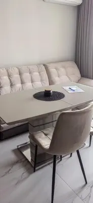 a living room with a table and a couch at Apartmenthaus Oborishte - 17 in Panagyurishte
