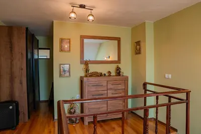 a room with a wooden dresser and a mirror at Alpine Retreat Maisonette in Bansko