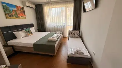 a bedroom with a bed and a bench in it at Апартамен за гости Панови in Plovdiv