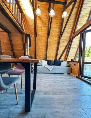 a room with a couch and a table in a building at Алпийска вила в полите Рила in Resilovo