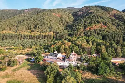 an aerial view of a house in the middle of a mountain at Алпийска вила в полите Рила in Resilovo
