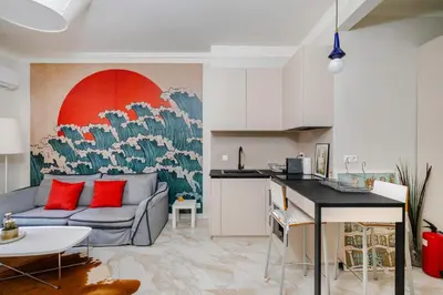 a living room with a couch and a kitchen at Stylish 1BD Apartment in the Heart of the City by Flat Mаnager in Sofia