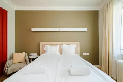 a bedroom with a large bed with white sheets at Stylish 1BD Apartment in the Heart of the City by Flat Mаnager in Sofia