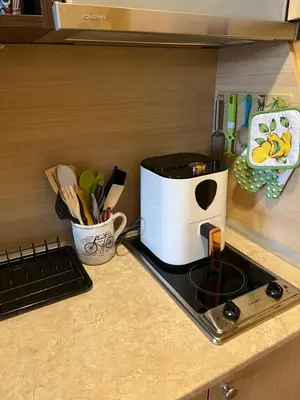 a kitchen counter with a coffee maker on a stove at Aspen Suites Студио Слънчев ден in Razlog