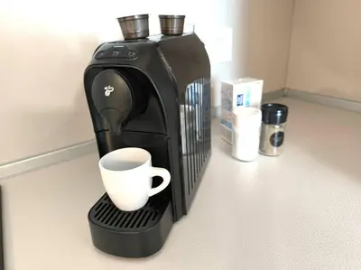 a coffee maker with a cup on a counter at My Campus 1 bdrm, Romantic, Panorama view, Free parking, Self check-in in Sofia