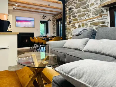 a living room with a couch and a glass table at Spa Villa Mezinska Jacuzzi Sauna in Shiroka Lŭka