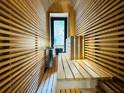 a room with a wooden wall with a window at Spa Villa Mezinska Jacuzzi Sauna in Shiroka Lŭka