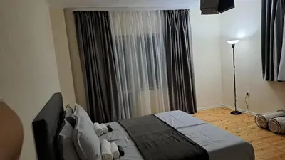 a bedroom with a bed in front of a window at Apart Viki in Sandanski