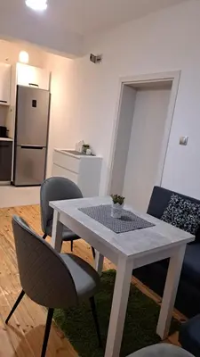 a white table and chairs in a living room at Apart Viki in Sandanski