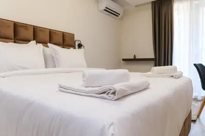 two towels are sitting on top of a white bed at LDV 13 1-Bedroom Apartments Free private parking in Plovdiv