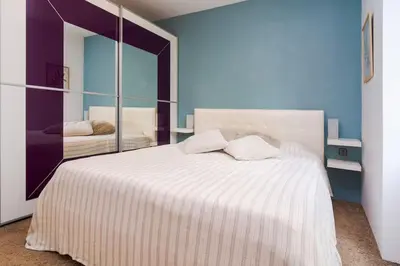 a bedroom with a large white bed with a mirror at Spacious and modern apt, 6 guests, Central station, self check-in in Sofia